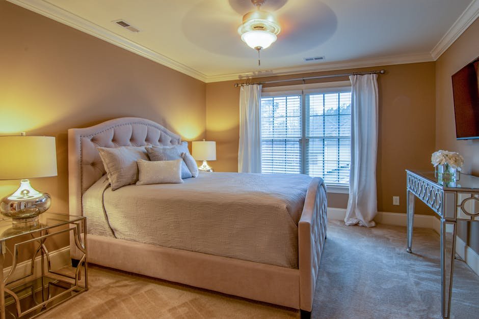 Spacious modern bedroom with beige and white decor, capturing a cozy and elegant ambiance.